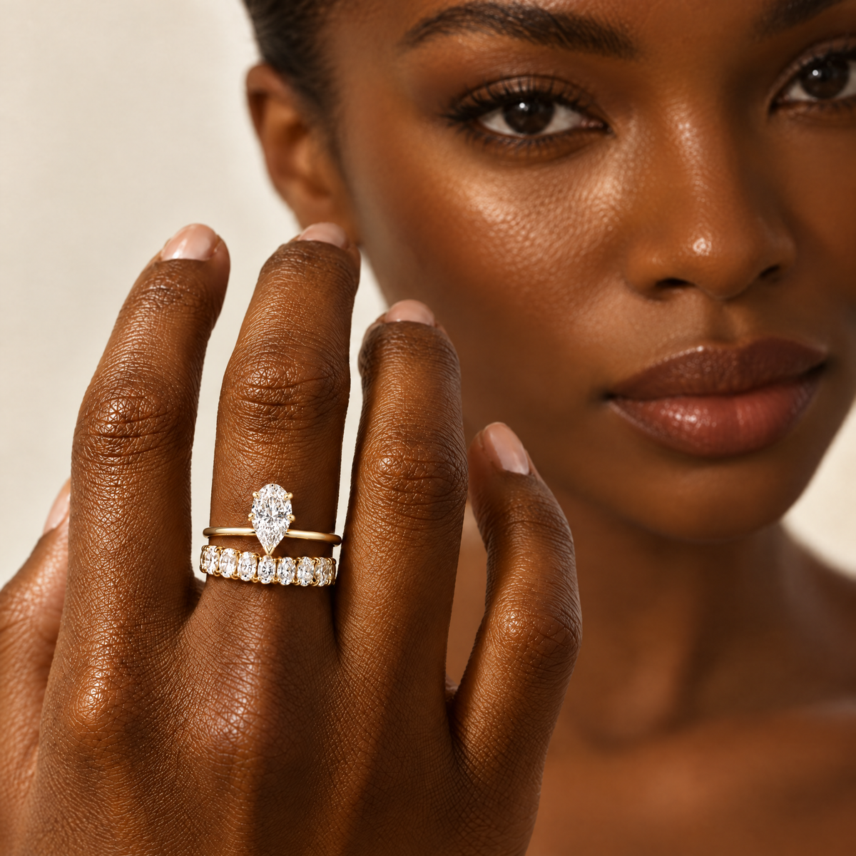 Pear Solitaire Ring stacked with an oval eternity band