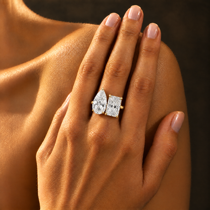 Toi et Moi Pear & Radiant Ring worn on the hand in warm light