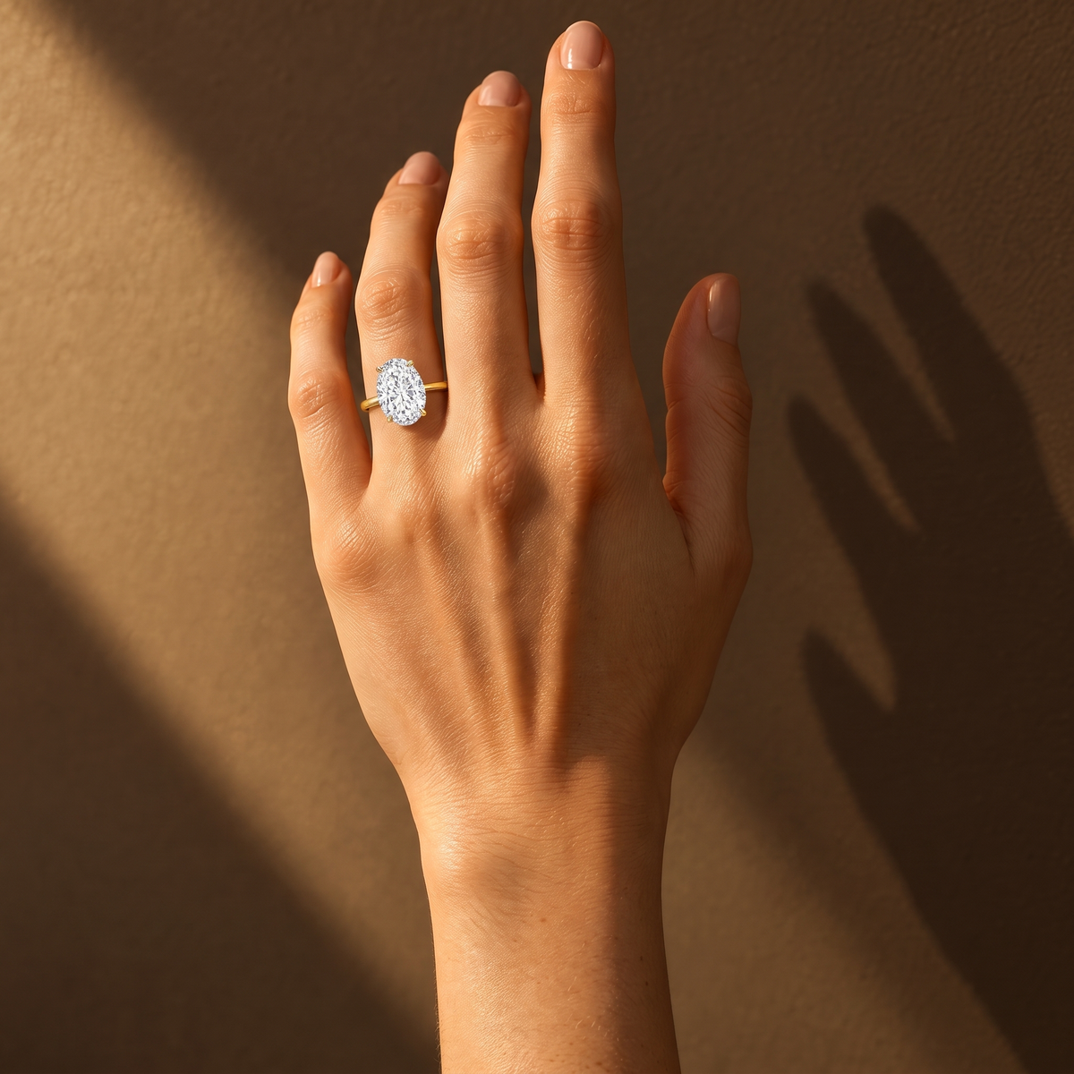 Grand Oval Solitaire Ring worn on the hand in sunlight