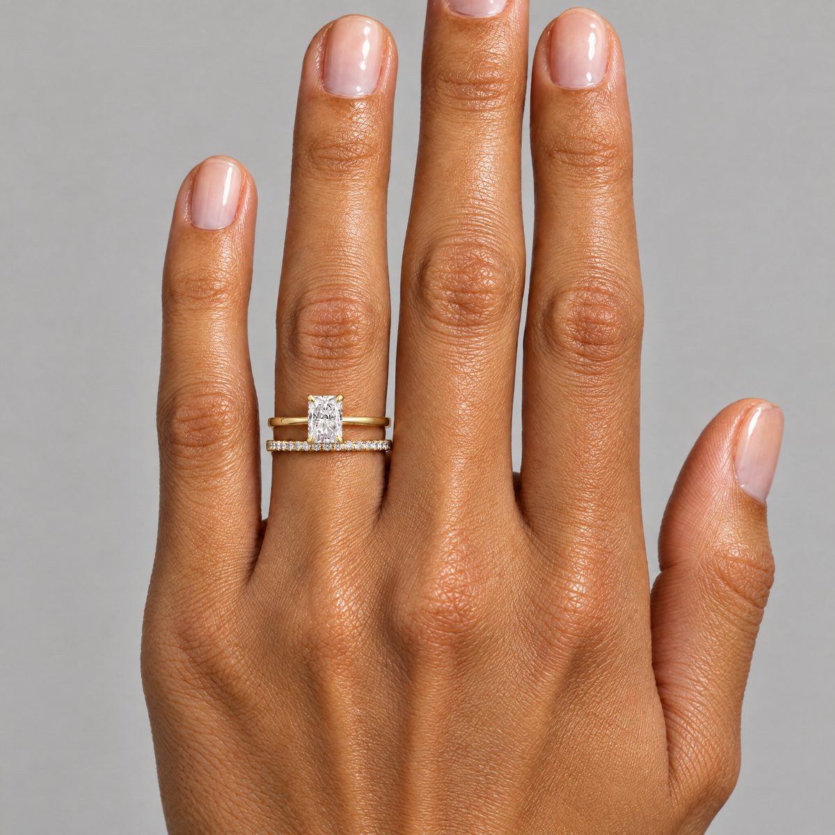Radiant-Cut Solitaire Ring worn with a neutral outfit