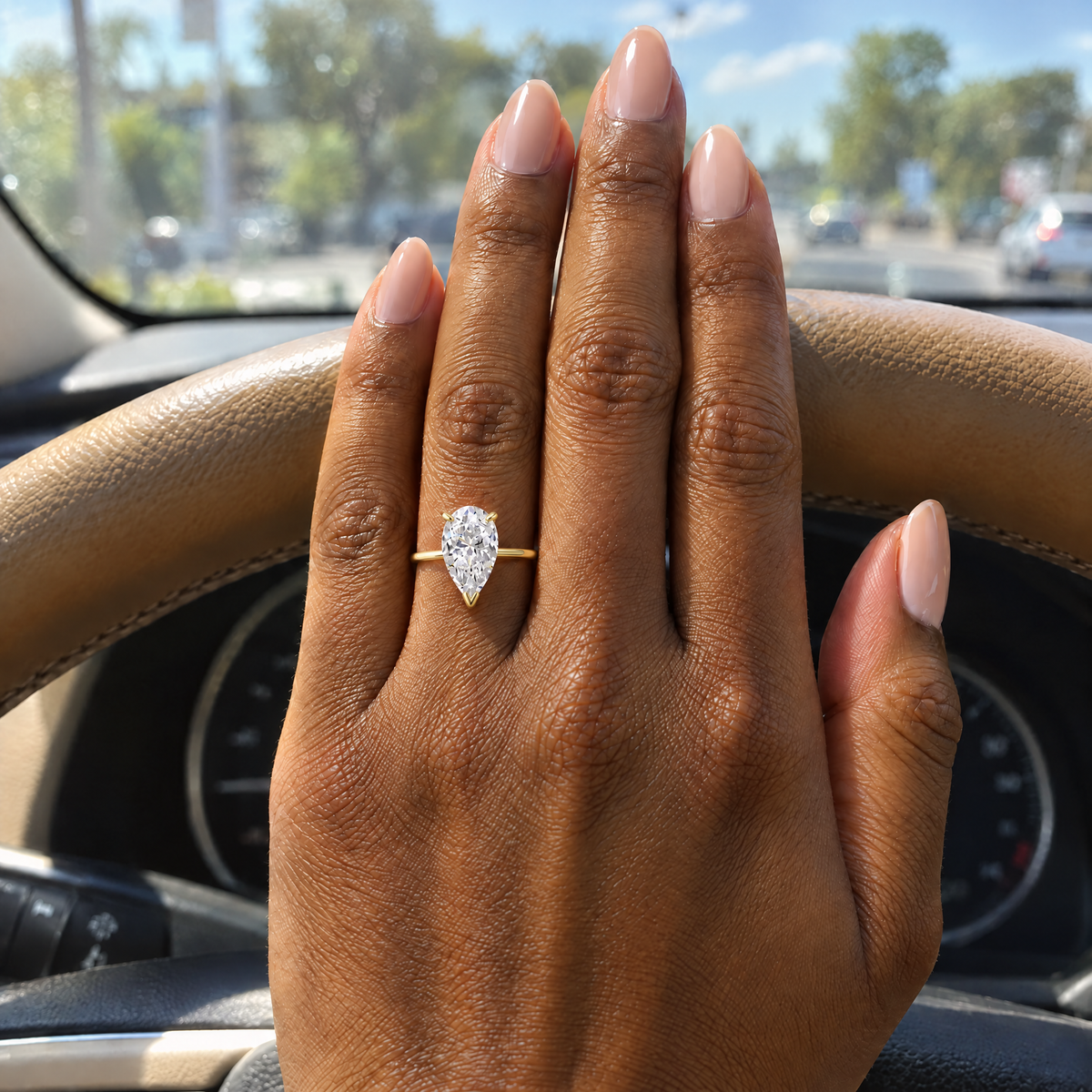 Pear Solitaire Ring worn on the hand in daylight