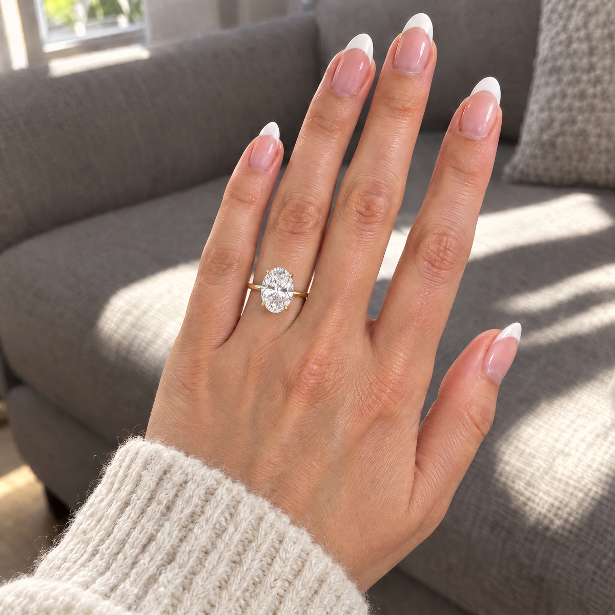 Grand Oval Solitaire Ring worn on the hand in daylight