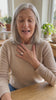 Woman in her sixties smiling and showing the Grand Oval Solitaire Ring