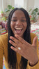 Woman laughing and showing the Grand Oval Solitaire Ring