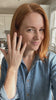 Woman showing the Pear Solitaire Ring
